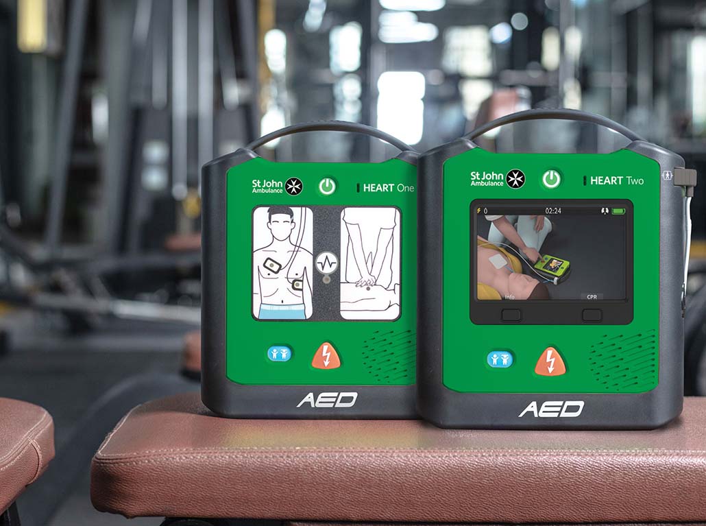 two heard defibrillators on a bench in gym