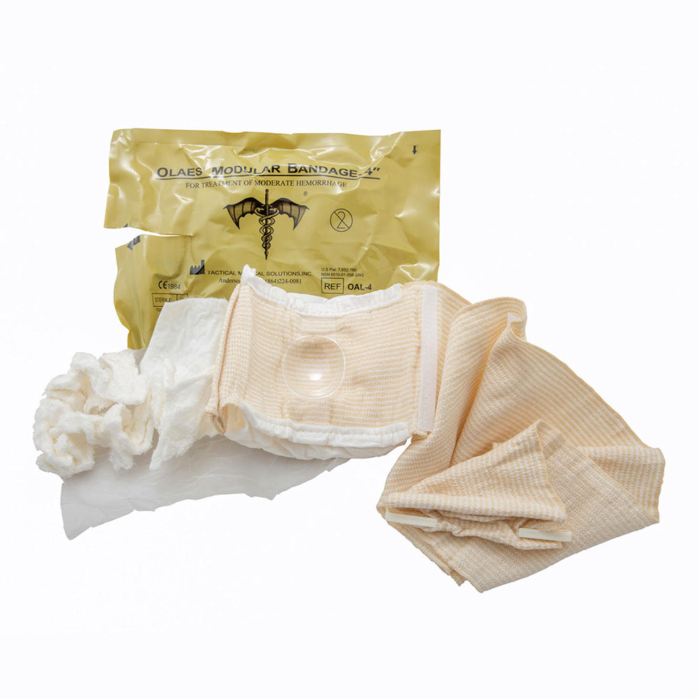 An opened packet of the TacMed OLAES 4 inch Modular Bandage.