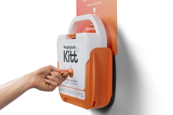Hand removing an anaphylaxis emergency kit from a wall-mounted orange and white storage unit containing adrenaline auto-injectors.