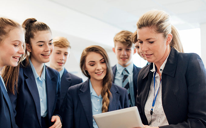 pupils gathering round screen with teacher