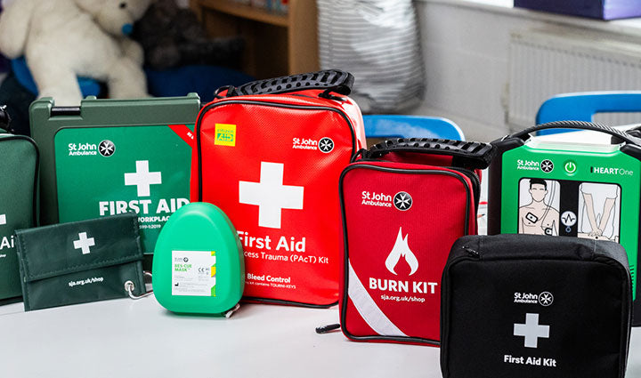 Collection of St John Ambulance first aid kits on a table