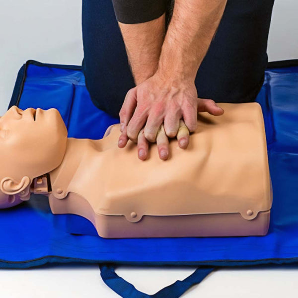 A person practising chest compressions on the PractiMan Advanced CPR Manikin Light.