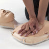 A person practicing CPR on the Laerdal Mini Anne.