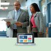 School staff engaging in a conversation, looking at a tablet.
