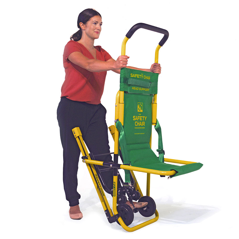 A learner handling an evacuation chair.