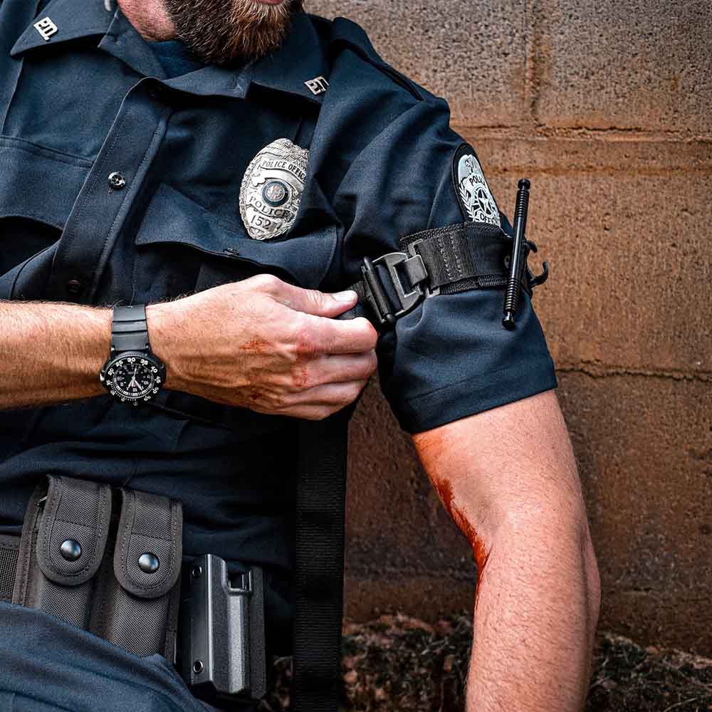 A police office using the TacMed SOF Tourniquet on himself.