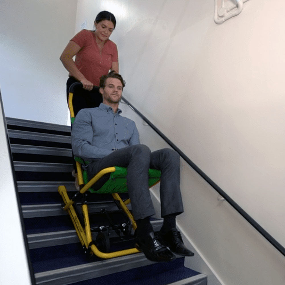 A woman using the Safety Chair EV-4000 to transport a passenger down a flight of stairs.