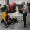 A learner and instructor on a First Aid and Specialist Trauma (FAST) course, at a parking garage.