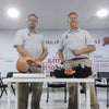 Two trainers in a classroom with their equipment on a desk, as part of a First Aid and Specialist Trauma (FAST) course.