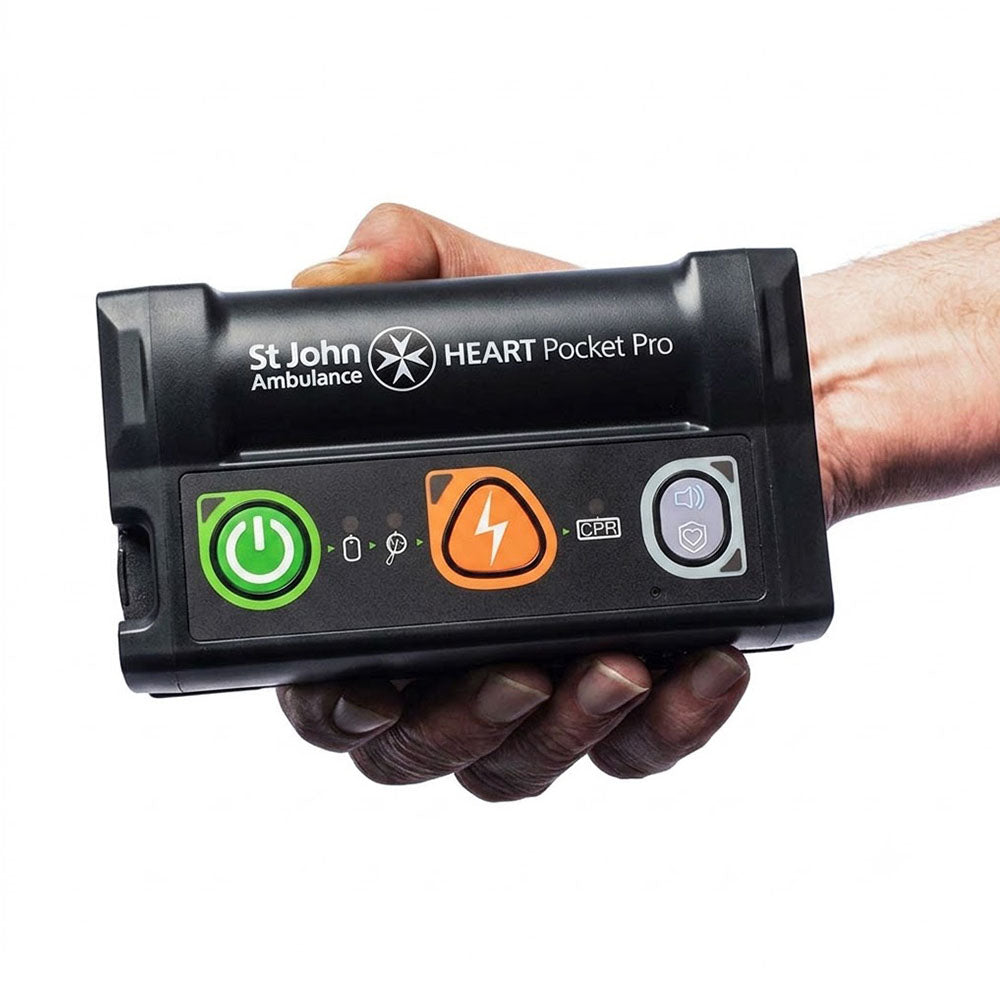 A close-up of a person holding the St John Ambulance HEART Pocket Pro Semi-automatic Defibrillator.
